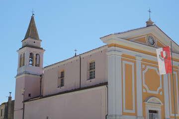 Historic Church of Our Lady of Angels in Porec, Croatia, with Croatian flag on facade, bell tower,...