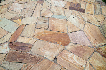 Background of irregular granite slabs of gray brown pink color, Briksha. Structures Backgrounds...