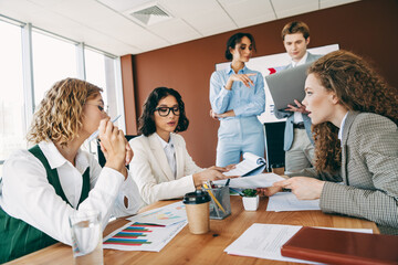 Team collaboration during a professional meeting in a modern office setting focused on planning and...