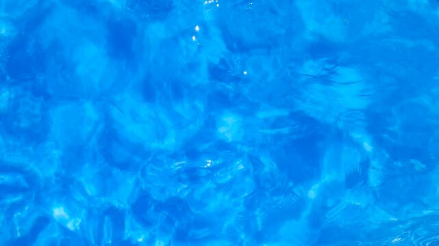 Blue water movement with top view into the pool. Relax background and texture.
