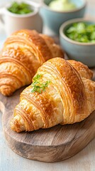 Golden-brown croissants on a wooden board, ready to be enjoyed. Fresh, flaky pastries with a delicious aroma