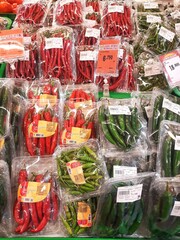 Fresh Red and Green Chili Peppers on Display at Supermarket