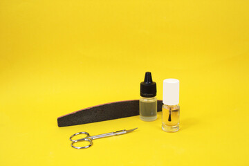 Manicure accessories on a yellow background.