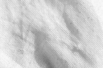 Textured plastic white woven fabric captured in a close-up view,