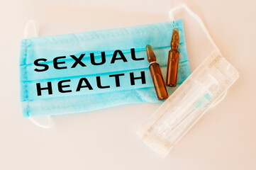 Blue surgical mask with the word sexual health written on it