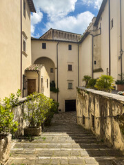 Serene vintage photo of stone stairs and historic buildings with greenery under a blue sky. Cultural heritage concept. Perfect for