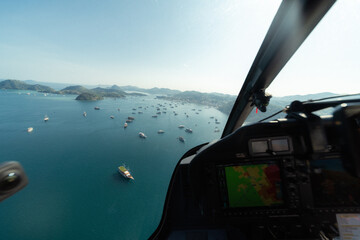 An incredible aerial perspective of Labuan Bajo captured from a helicopter, sitting beside the...
