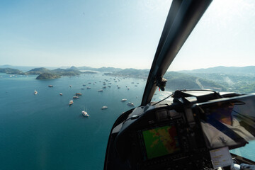 An incredible aerial perspective of Labuan Bajo captured from a helicopter, sitting beside the...