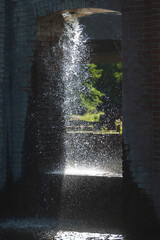 Waterfall in a city park. Water fountain in a city park.