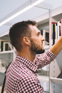Serious male buying book in bookstore