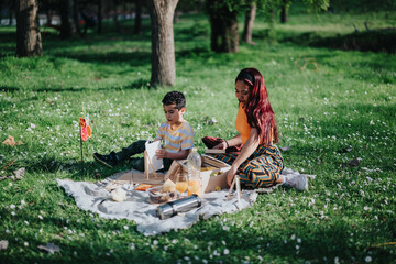 A young mother and her child enjoying a picnic outdoors with art supplies and refreshments, bonding...