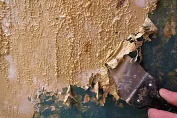 paint remover. Blistered paint. The master removes the old coating on the doors. The atmosphere of...