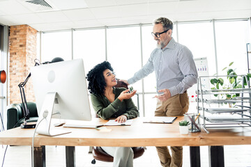 Professional colleagues collaborating in a modern office environment showcasing teamwork and...