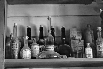A close-up of vintage apothecary bottles on a shelf at Black Creek Pioneer Village, capturing the essence of 19th-century charm and history.