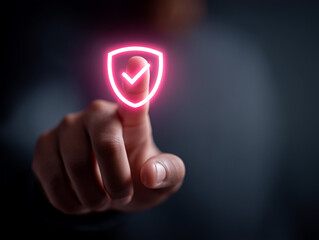 Finger touching a glowing shield icon with a checkmark