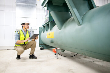 asian male engineer is working on a Cooling system pipeline