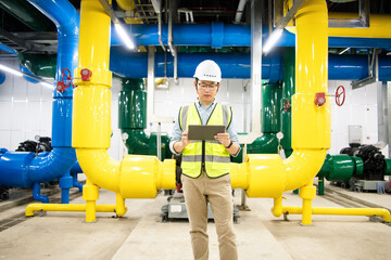 asian male engineer is working on a Cooling system pipeline