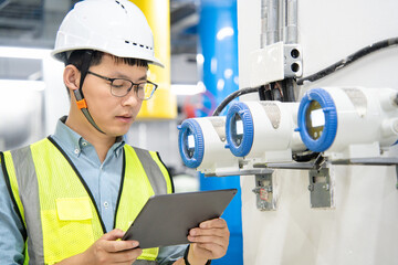 asian male engineer is working on a Cooling system pipeline