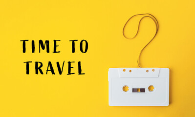 White cassette tape is hanging from a string