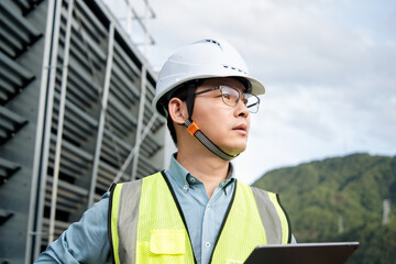 The engineer is working on the refrigeration system on the roof.