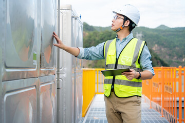 The engineer is working on the refrigeration system on the roof.