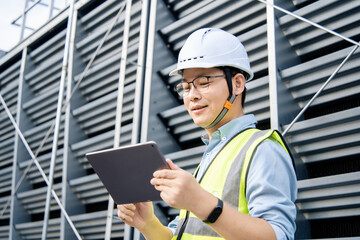 The engineer is working on the refrigeration system on the roof.