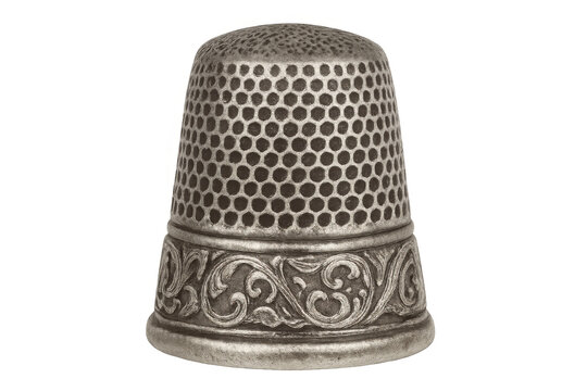 Vintage metal thimble featuring intricate floral embossing, gleaming with detailed craftsmanship, ideal for professional sewing and decorative needlework