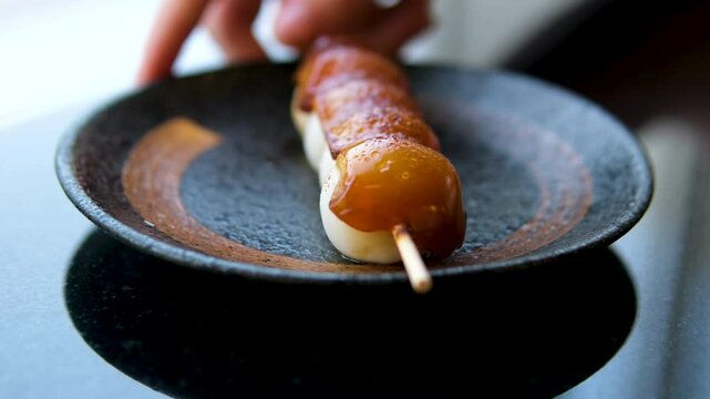 Mitarashi dango three pieces Japanese traditional sweets dango. High quality 4k footage