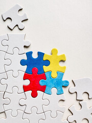 Colorful puzzle pieces symbolizing Autism Awareness Day on a white background