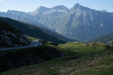Rocky Alpine Slopes with Grassy Trails and Rugged Peaks at Splugen Pass: Serene Mountain Landscape...