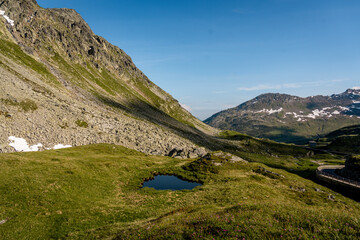 Rocky Alpine Slopes with Grassy Trails and Rugged Peaks at Splugen Pass: Serene Mountain Landscape...