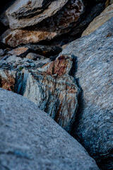 Textured Rock Surface With Layers Of Striated Minerals: Close-Up Of Weathered Geological Formation...