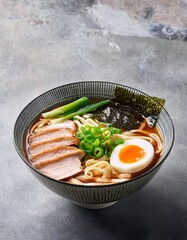 A delicious bowl of ramen featuring soft-boiled egg, slices of tender pork, fresh vegetables, and noodles in a rich, savory broth. A perfect representation of authentic Japanese cuisine. AI