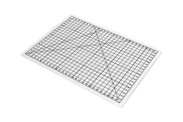 White rectangular cutting mat with printed grid is isolated.