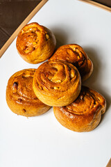 vertical top view photo of whole wheat artisan bread mogolla style with peanuts, sweetened with honey, in a healthy vegetarian restaurant in Colombia