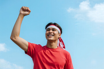 young man with arms outstretched for celebrate Indonesian independence day on 17 August.