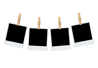 Four Blank Instant Photos Hanging from Clothespins on a String Isolated on a Black Background Ready for Your Memories