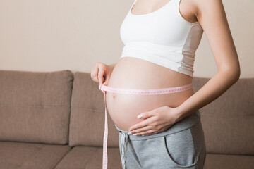 Health well being pregnancy lifestyle. Pregnant woman measuring her belly. Healthy pregnancy. Health well being pregnancy lifestyle