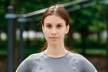 young slim athletic caucasian woman portrait, good sport shape, street sports ground outdoors in...