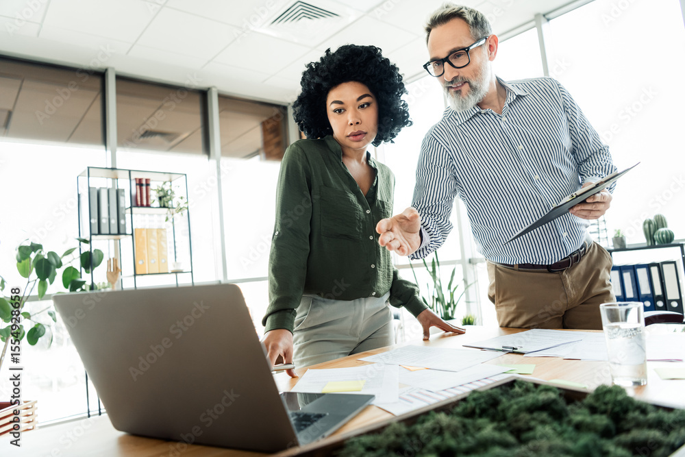 Poster diverse professionals collaborating on a business project together in a modern office setting with t
