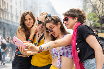 Four young women taking a selfie at gay pride parade