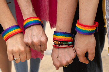 Activists showing support for lgbtq+ rights with rainbow bracelets