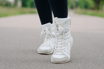 young slim beautiful caucasian woman running on path on river embankment in city park, black...