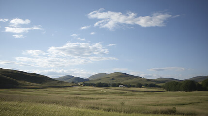 Fototapeta premium Serene rolling hills landscape under a blue sky with fluffy clouds