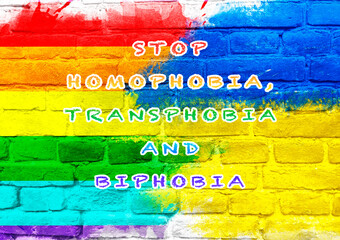 Colorful wall with the words Stop Homophobia, Transphobia, Biphobia