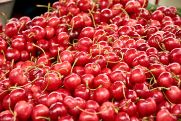 Fresh cherries from Provence, France, displayed at a market stall in Aix, ready for purchase.