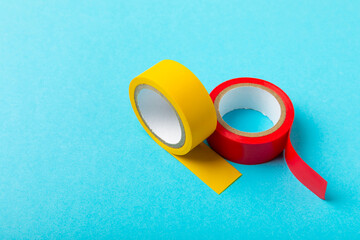 Insulating tape on a bright colored background. Set of different colors insulating tape. Reel...