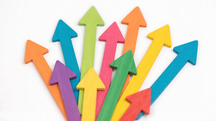 Multiple colorful wooden arrows pointing upwards in different directions on white background