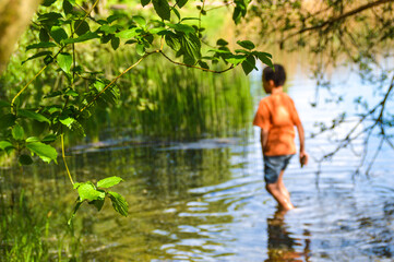 Young boy enjoying summer in the lake