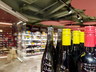 defocused alcohol (wine, champagne, liquor, whiskey) on store shelves